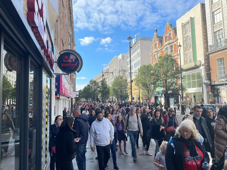 Crowds walking along a London shopping street during the funeral deployment.
