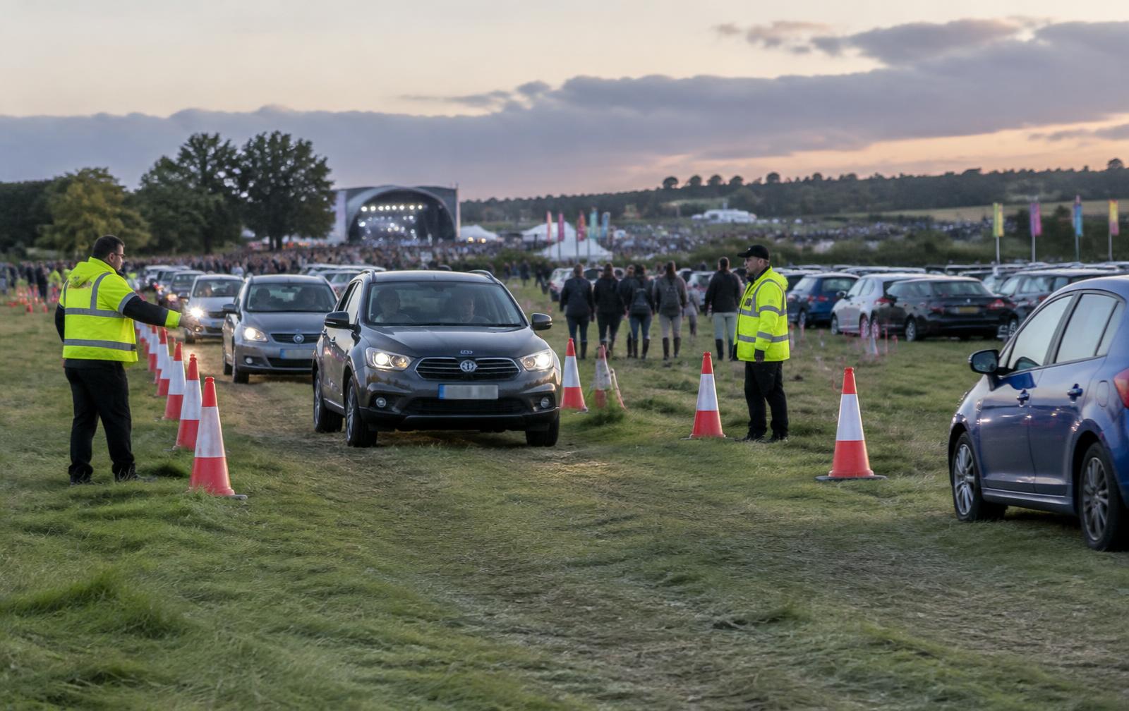 Personnel supporting vehicles through an organised temporary event car park